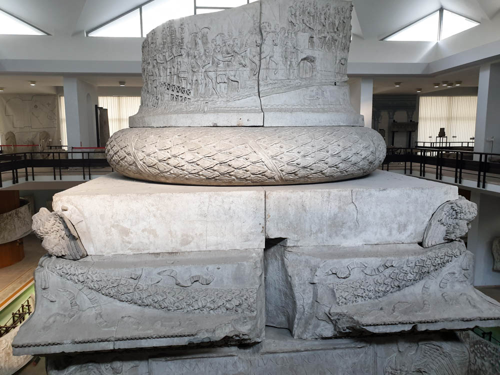 Large grey stone monument in a museum in Bucharest