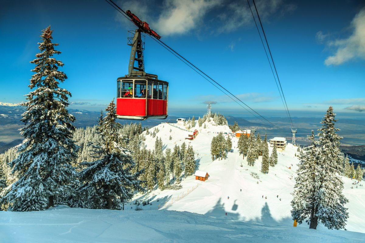 Red cable car moving down in Poiana Brasov famous ski resort,Carpathians,Transylvania,Romania,Europe