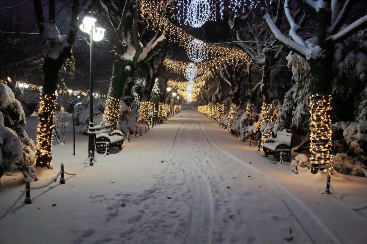 Snowy scene and Holiday lights in Cismigiu Park, Bucharest, Romania