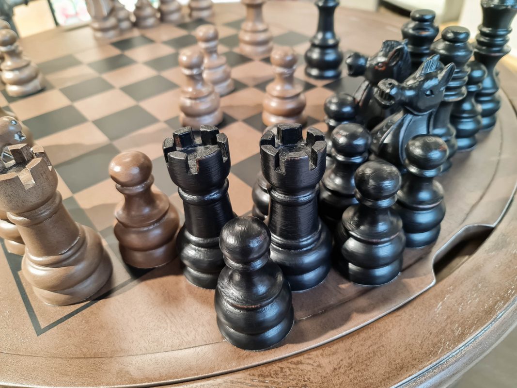 Close up of chess pieces on board game  Wooden vintage chess pieces on board game