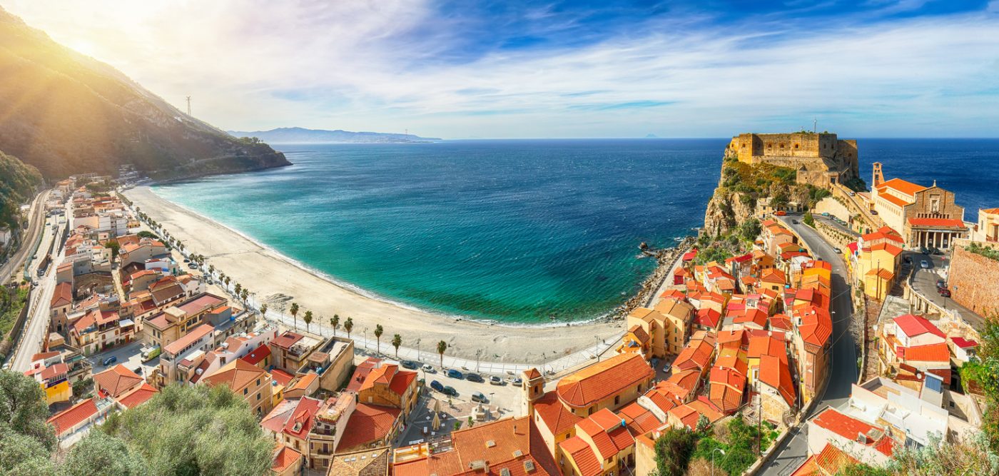 Aerial top view of sandy beach of Tyrrhenian sea bay gulf coast shore of beautiful seaside town village Scilla with green hill and Sicily island background, Calabria, Southern Italy