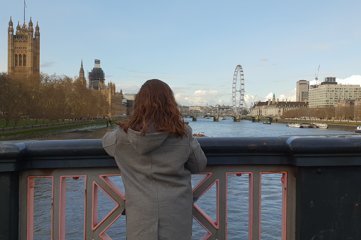 Girl in coast standing watching the River Thames