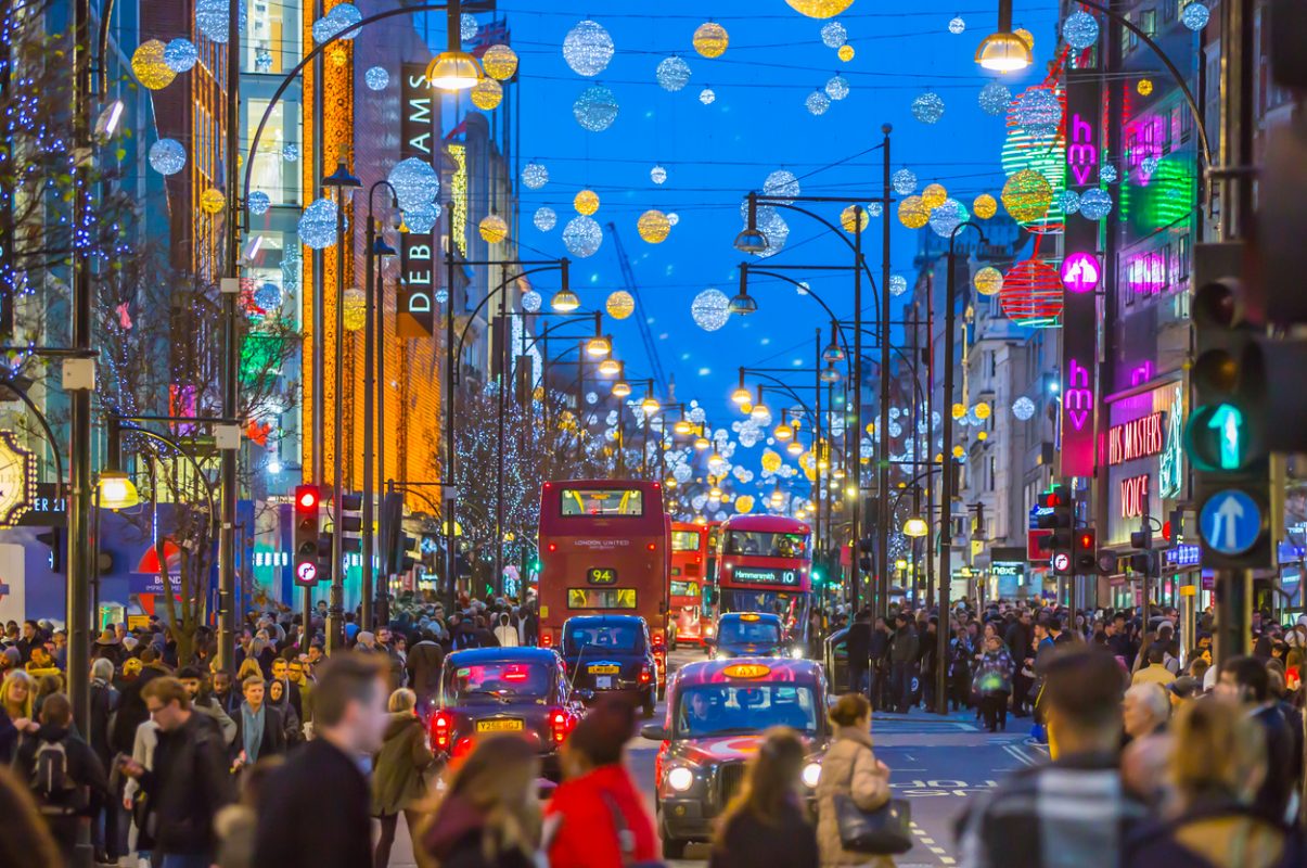 London, UK - December 30, 2015: Christmas lights decoration at Oxford street and lots of people walking during the Christmas sale, public transport, buses and taxies