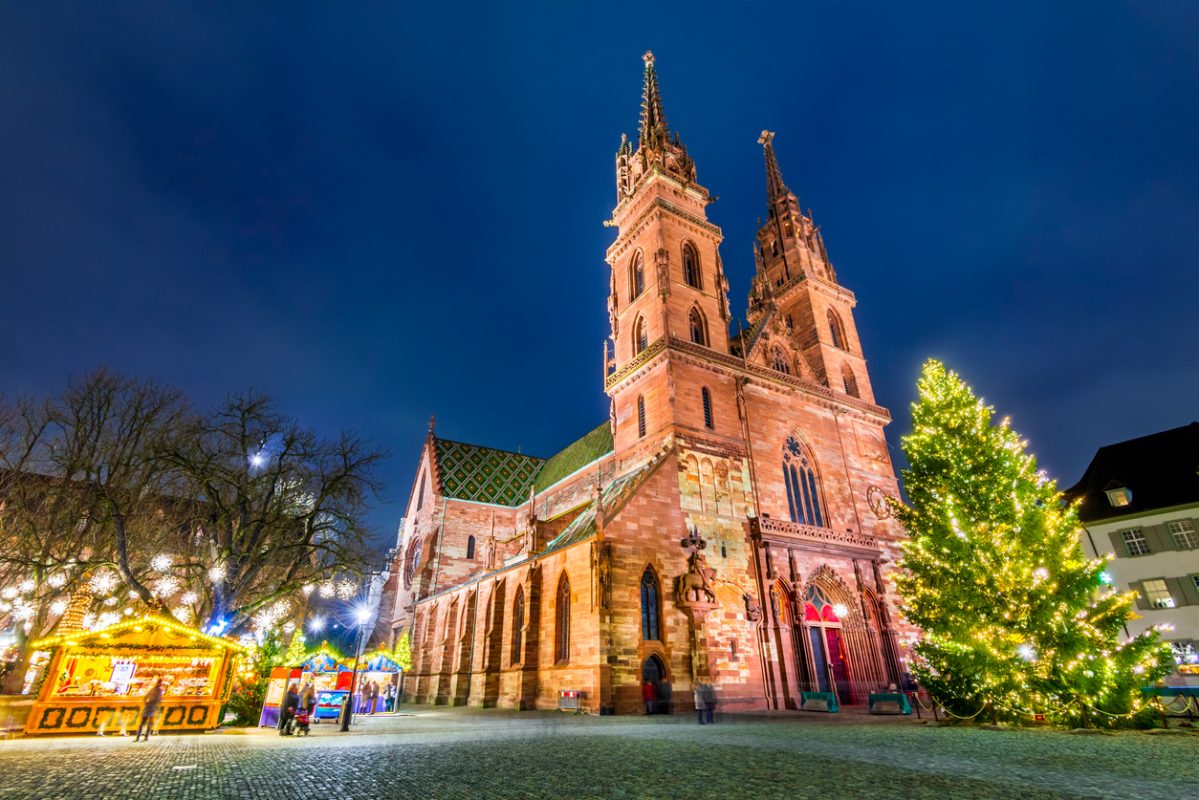 Basel, Switzerland. Christmas fairytale market at Munsterplatz and Munster Cathedral, Swiss Confederation.