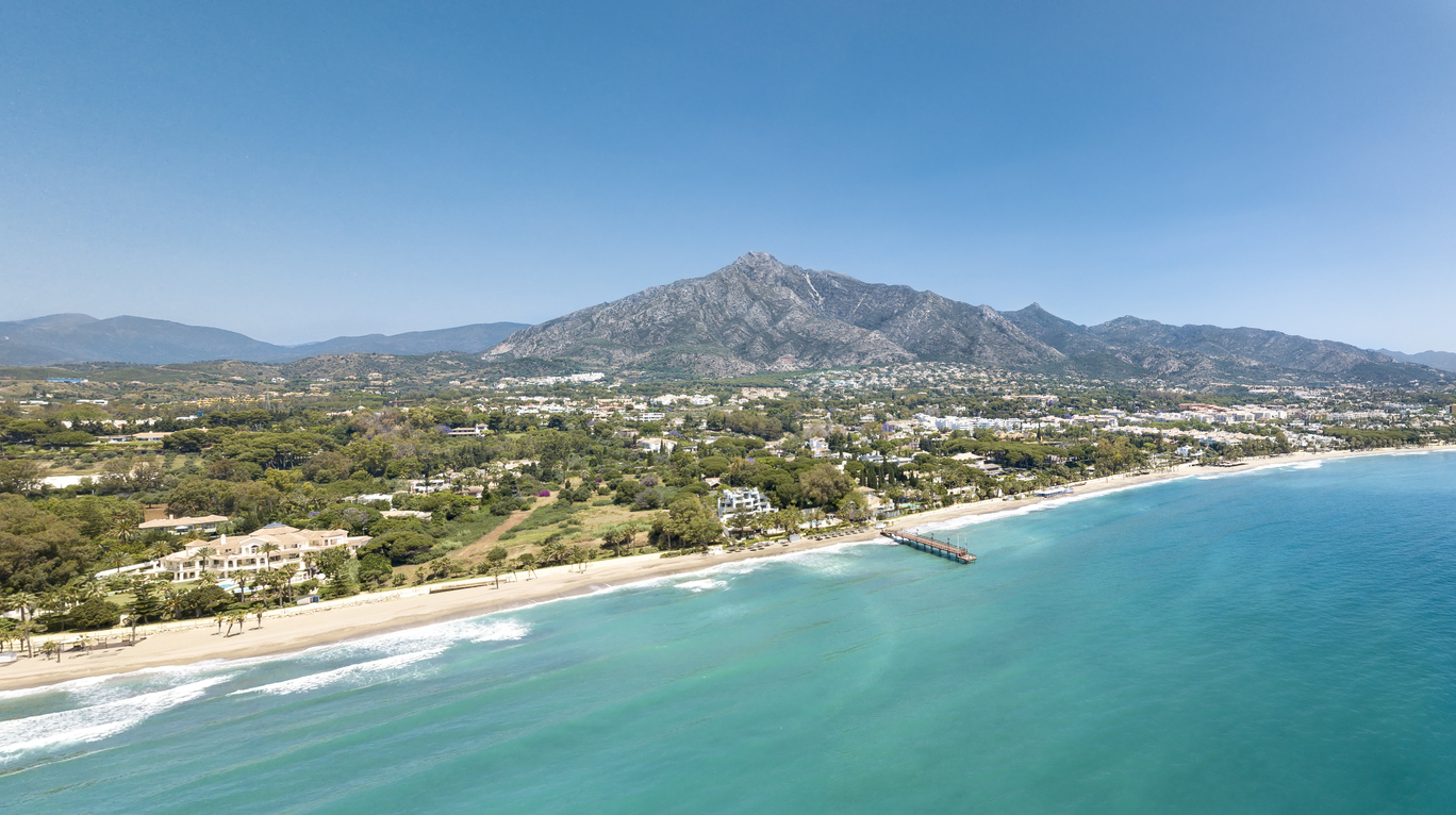 Panoramic aerial view of Casablanca and Puente Romano beach Marbella, Famous destination with luxury proprieties and restaurants. View of wood bridge Puente Romano and mountain La Concha.
