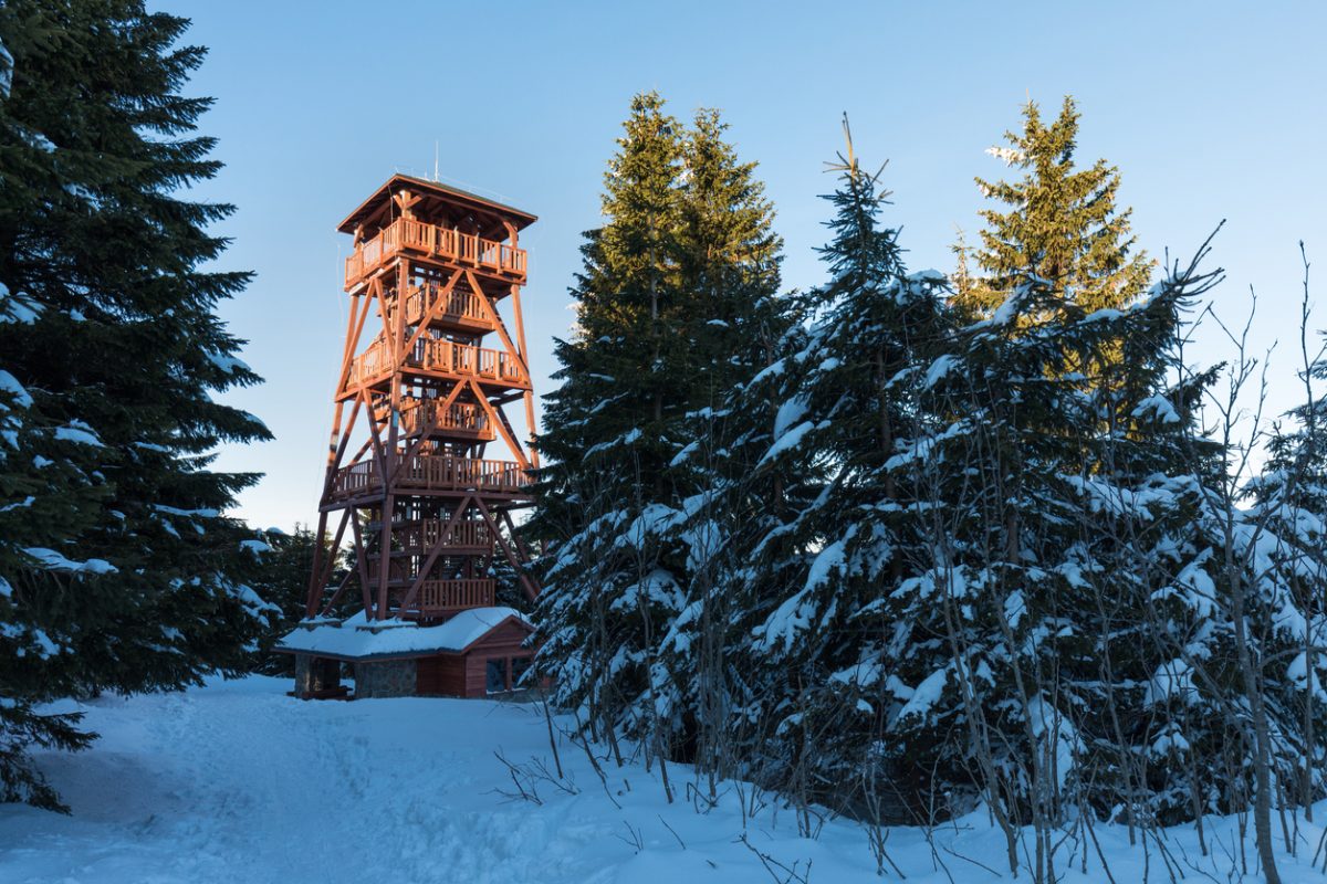 A new beautiful wooden lookout tower at the top of the Vrchmezí peak. Winter landscape near Zieleniec ski arena, Eagle mountains, Poland
