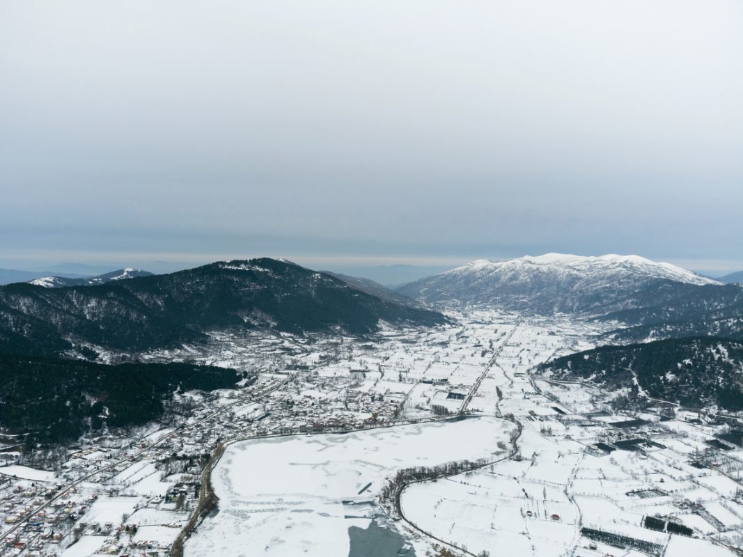 Aerial view of Frozen Golcuk lake and some mountains with Bozdag mountain at Odemis Izmir in winter season.