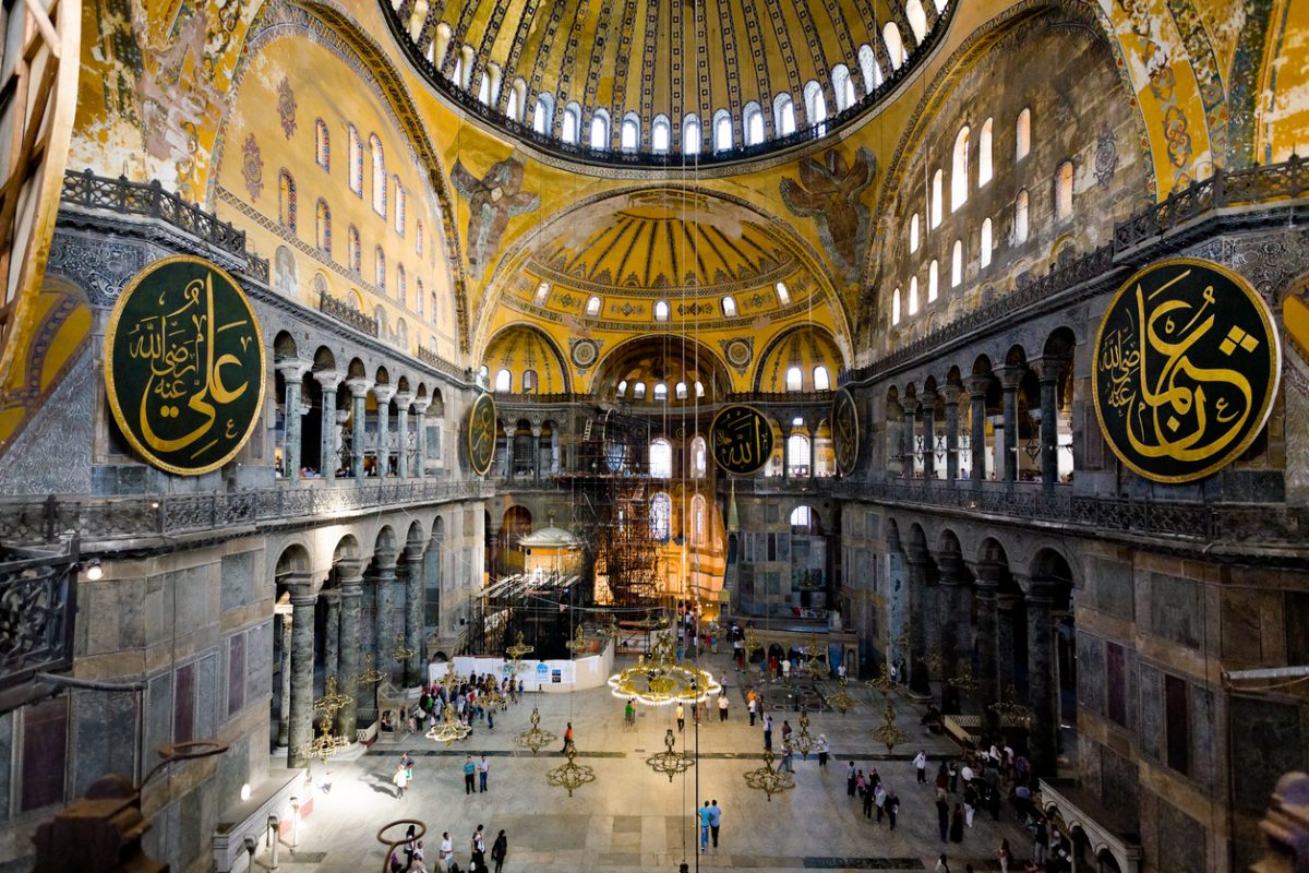 Istanbul, Turkey - September 10, 2010: tourists visiting the interior of Aya Sophia - ancient Byzantine basilica. For almost 500 years the principal mosque of Istanbul, Hagia Sophia served as a model for many other Ottoman mosques