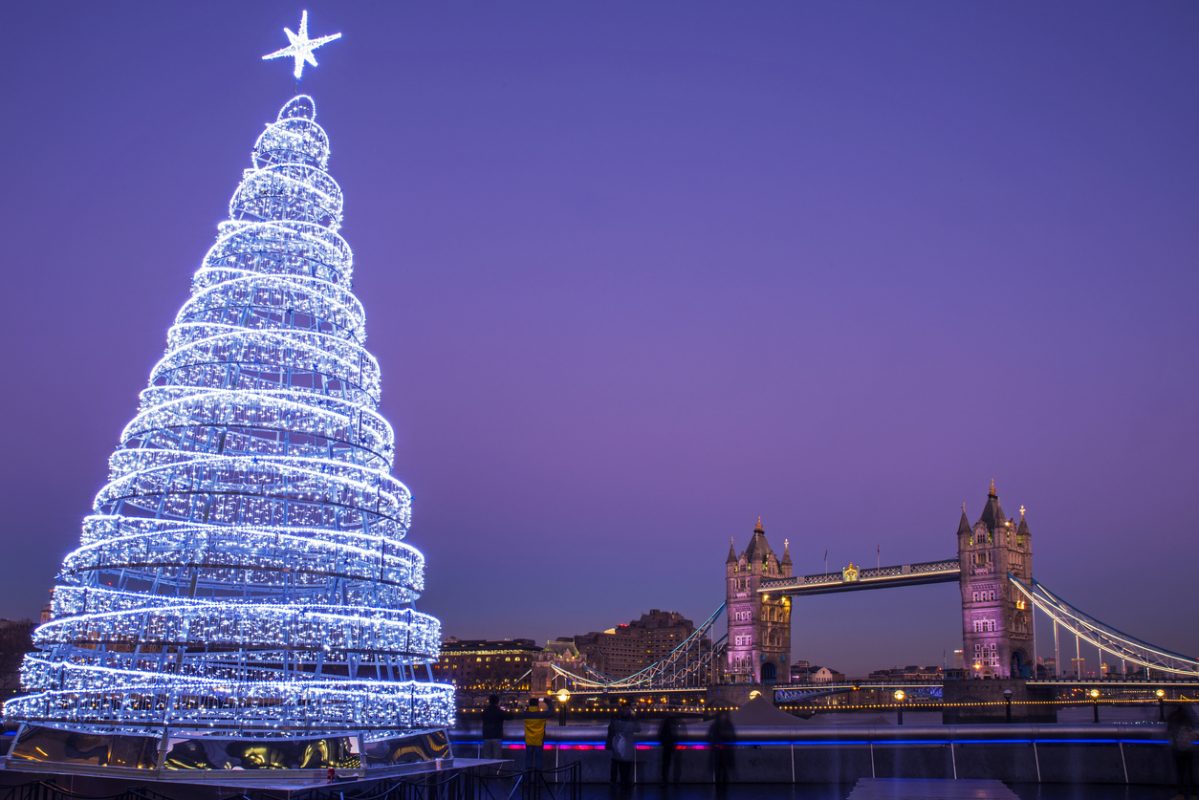 London, UK - December 29th 2016: A view of the magnificent Tower Bridge with an illuminated Christmas Tree in London.