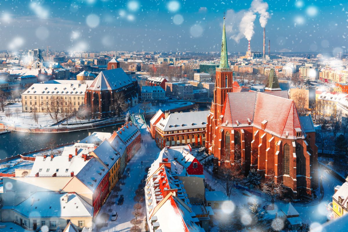 Aerial view of Ostrow Tumski with church of the Holy Cross and St. Bartholomew from Cathedral of St. John in the winter snowy morning in Wroclaw, Poland