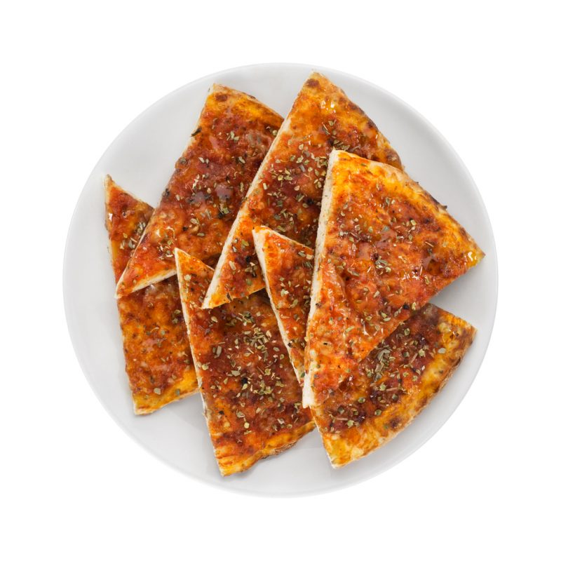 Slices of garlic bread with tomato sauce and thyme. Garlic bread on white plate. Isolated slices of garlic bread on white background.