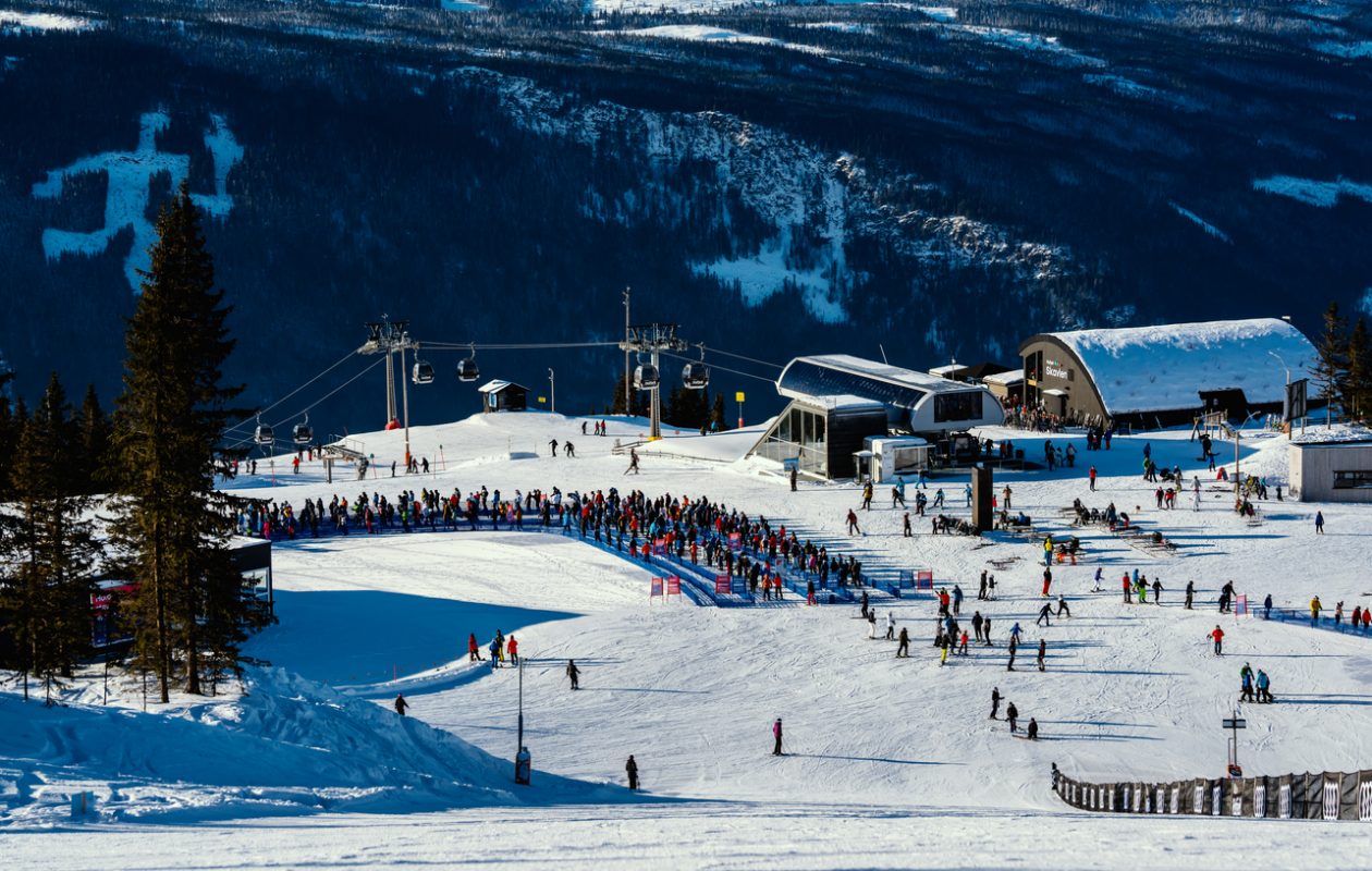 Hafjell, Norway - Feb. 6th 2021: People standing in line by the ski lift at Hafjell ski resort in Norway.
