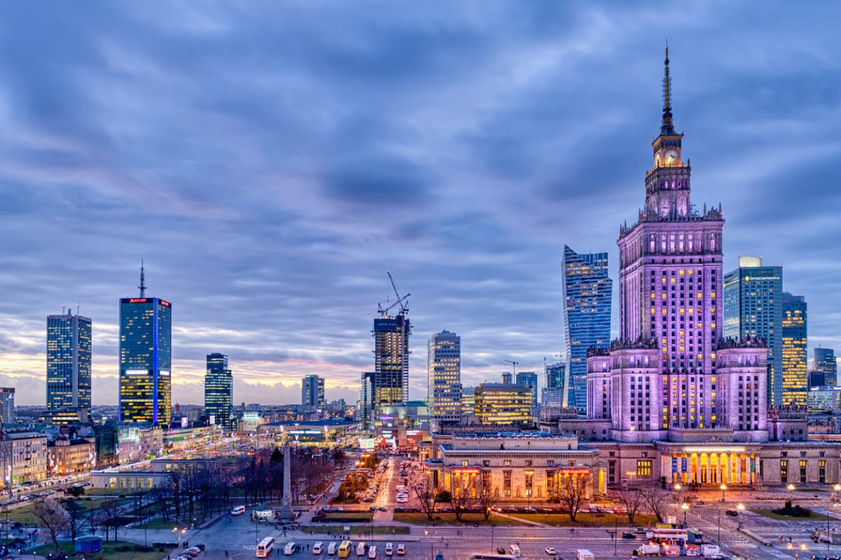Warsaw, Poland - January 22, 2020: High angle panoramic view of Warszawa cityscape skyline with centralna train station and palace of culture night evening