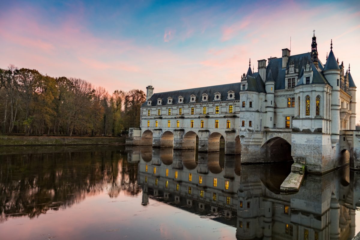 Chenonceaux,France - November 10, 2015: Chateau de Chenonceau Loire Valley France at sunset with reflection of building and sky in the River Cher