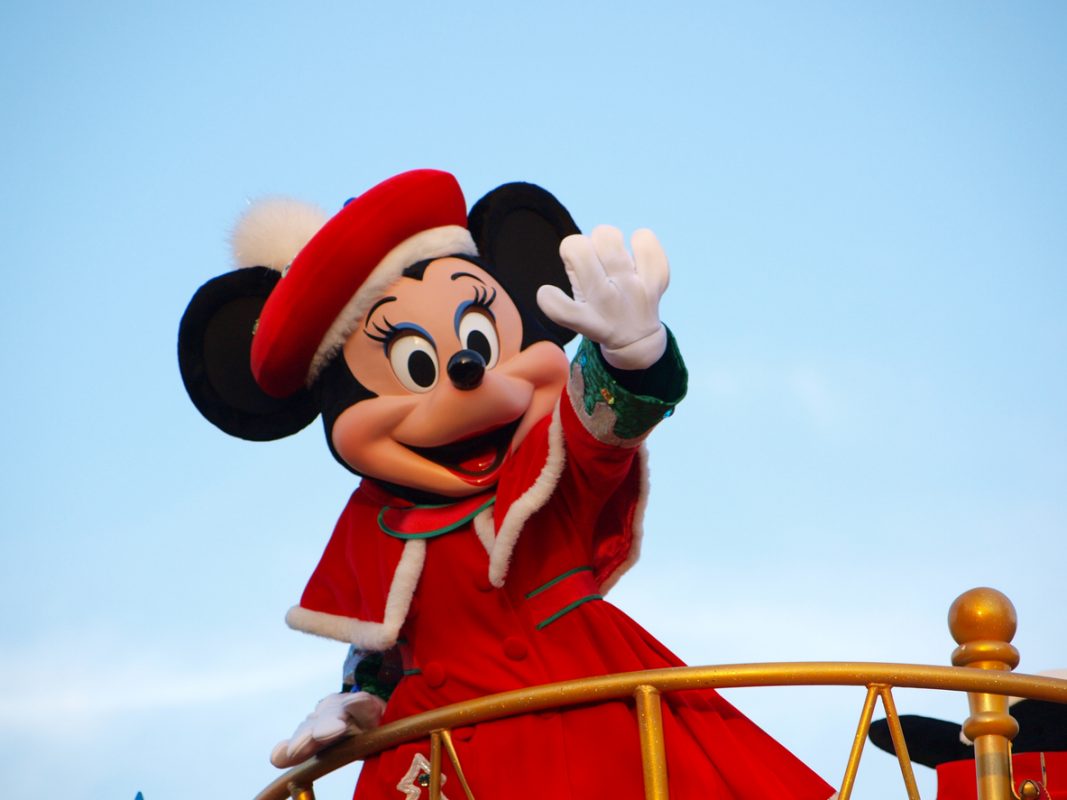 Tokyo, Japan - December 14, 2012: Minnie Mouse in the red coat waving her hand in daytime Parade at Tokyo-Disneyland, Tokyo, Japan.