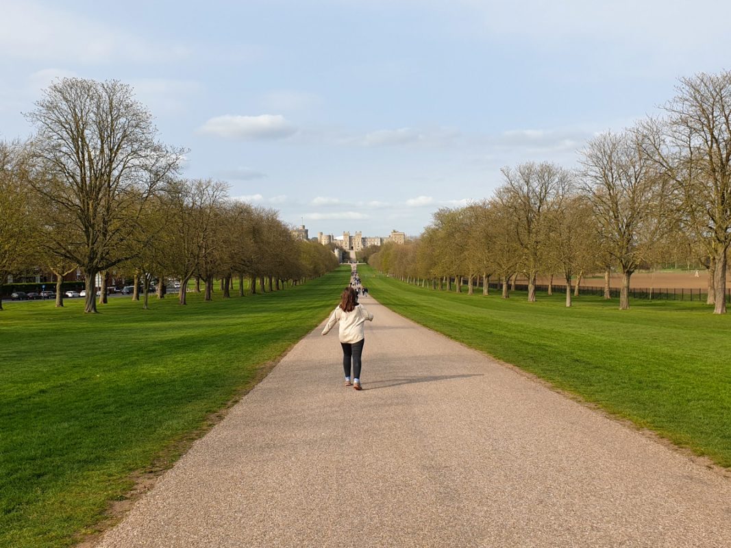 Girl walking towards Windsor Castle on a warm day in February