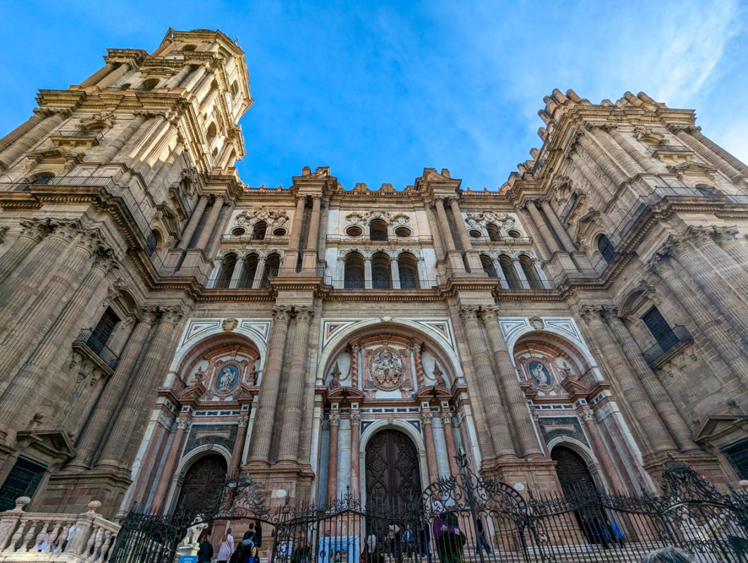 The domineering cathedral of Malaga, with towers and detailing. 