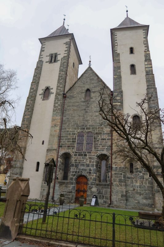 Bergen's historic church with two cream towers and a building in the middle