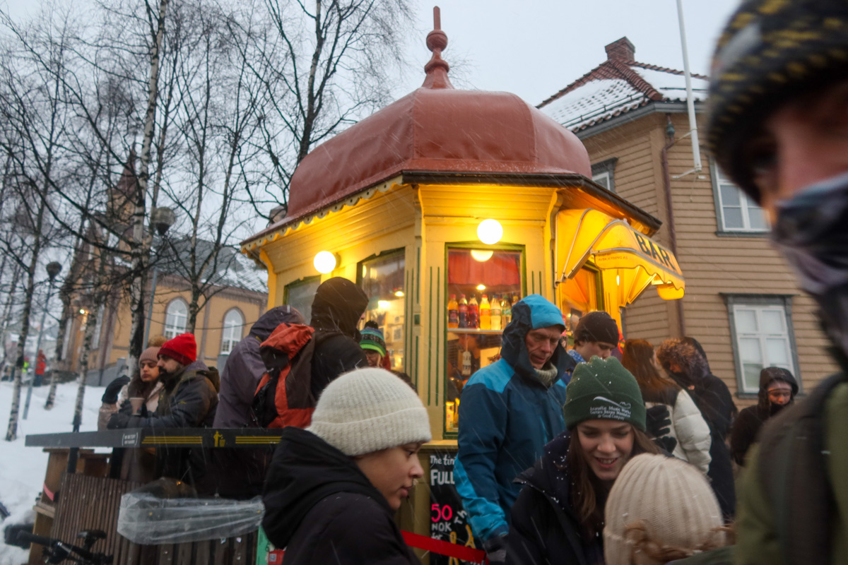 The world's smallest bar in Tromso, with a sea of people's heads in front