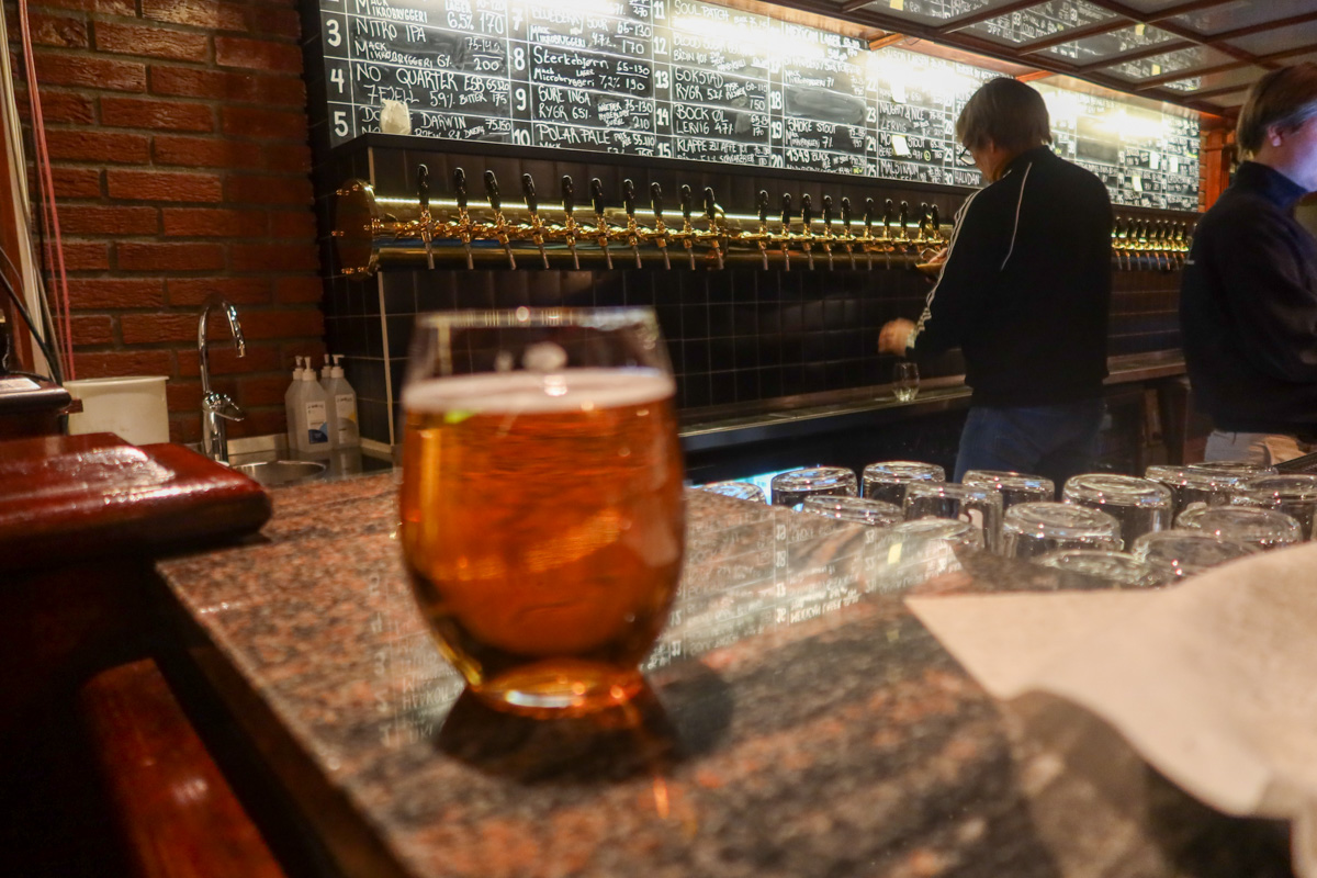 A ginger beer in Mack's brewery, with serving taps in the background