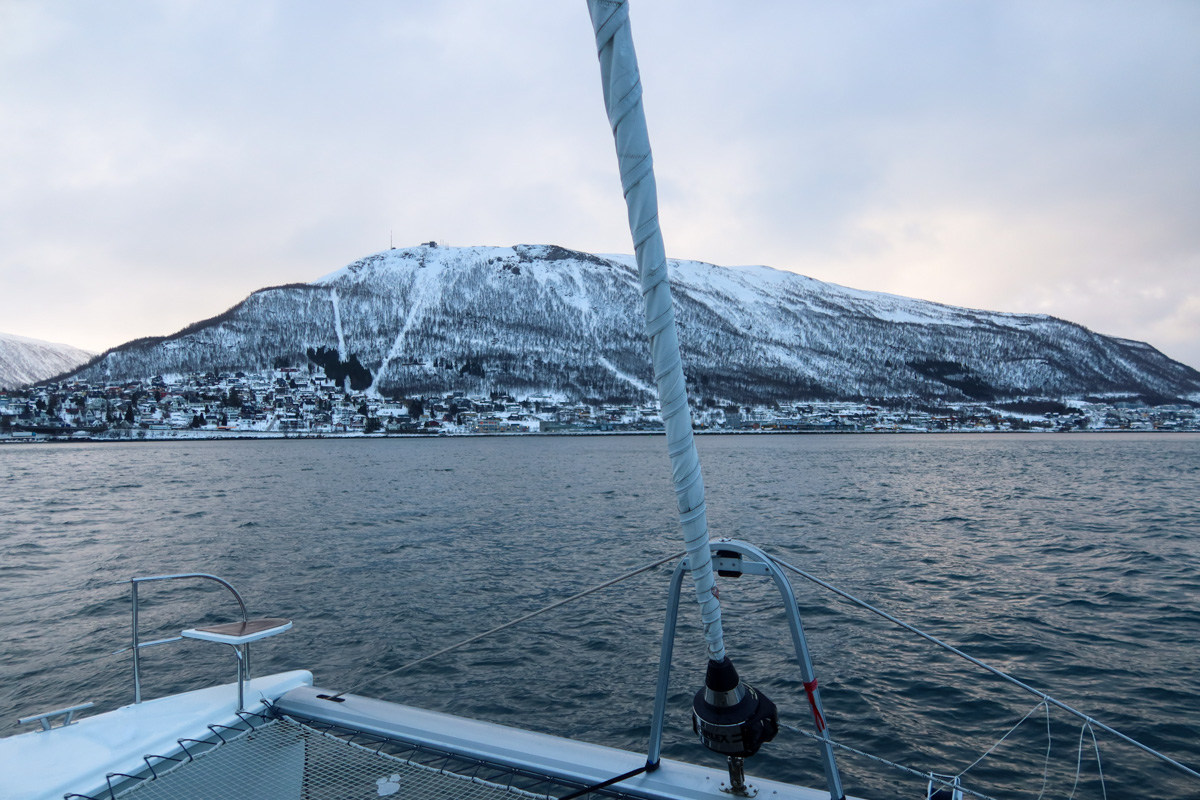 Fjord safari near Tromso, with snow-covered hills in the background and the cold water in the foreground