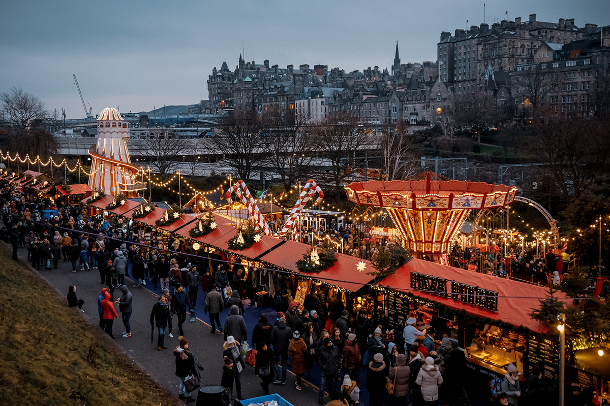 Christmas market around Scott monument in the city of Edinburgh, United Kingdom