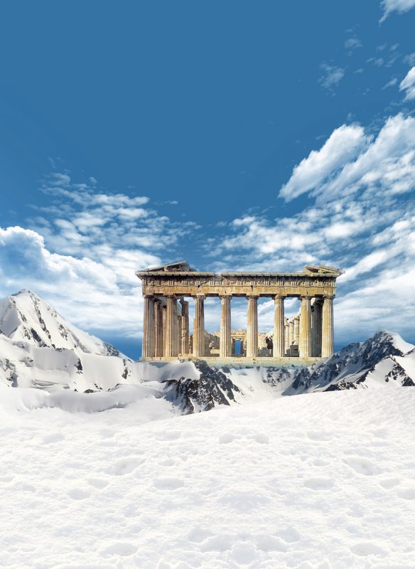 Parthenon, greek landmark, among the mountains with snow and blue sky and clouds in the background