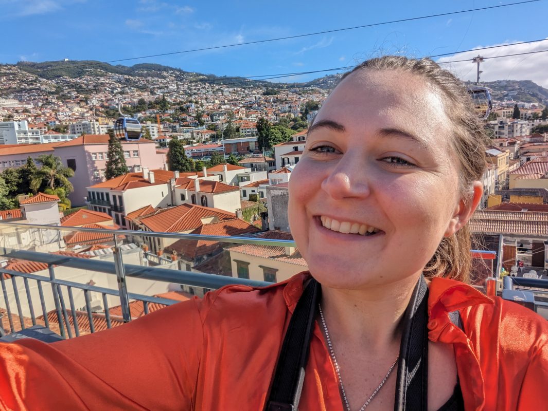 Claire smiling with a background of Funchal behind her.