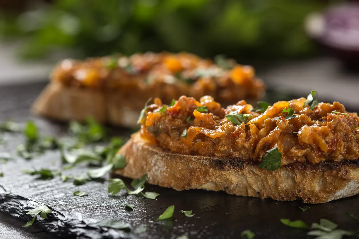 Zacusca - Romanian vegetable spread, with fish, roasted eggplant, onions tomato paste, and roasted red peppers