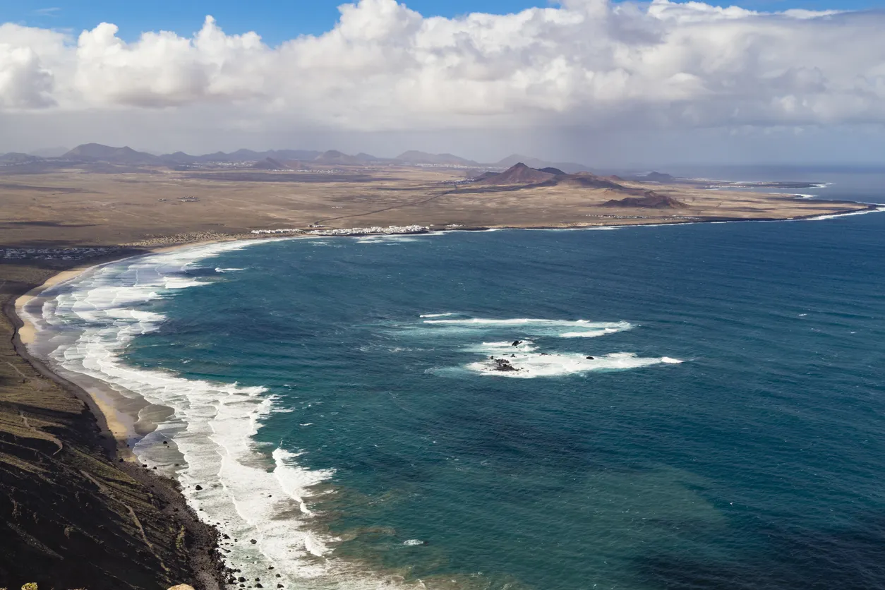 La Caleta de Famara and fire mountain, Lanzarote, Canary Islands, Spain