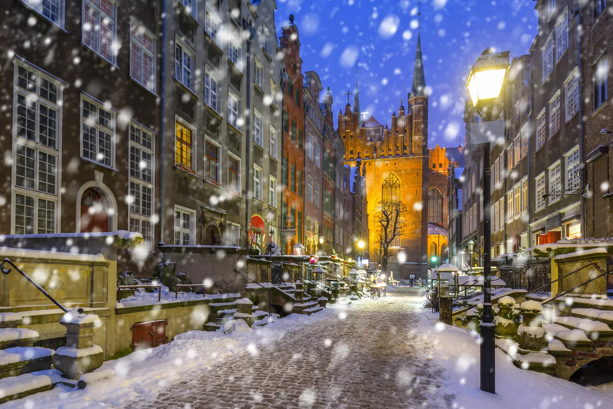 Old town of Gdansk on a cold winter night with falling snow, Poland