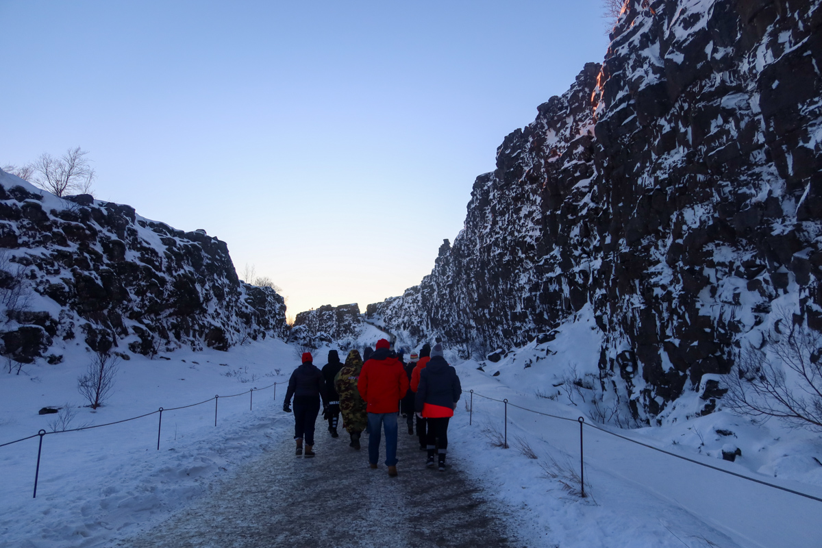 Group walking through Thingvellir National Park in the snow