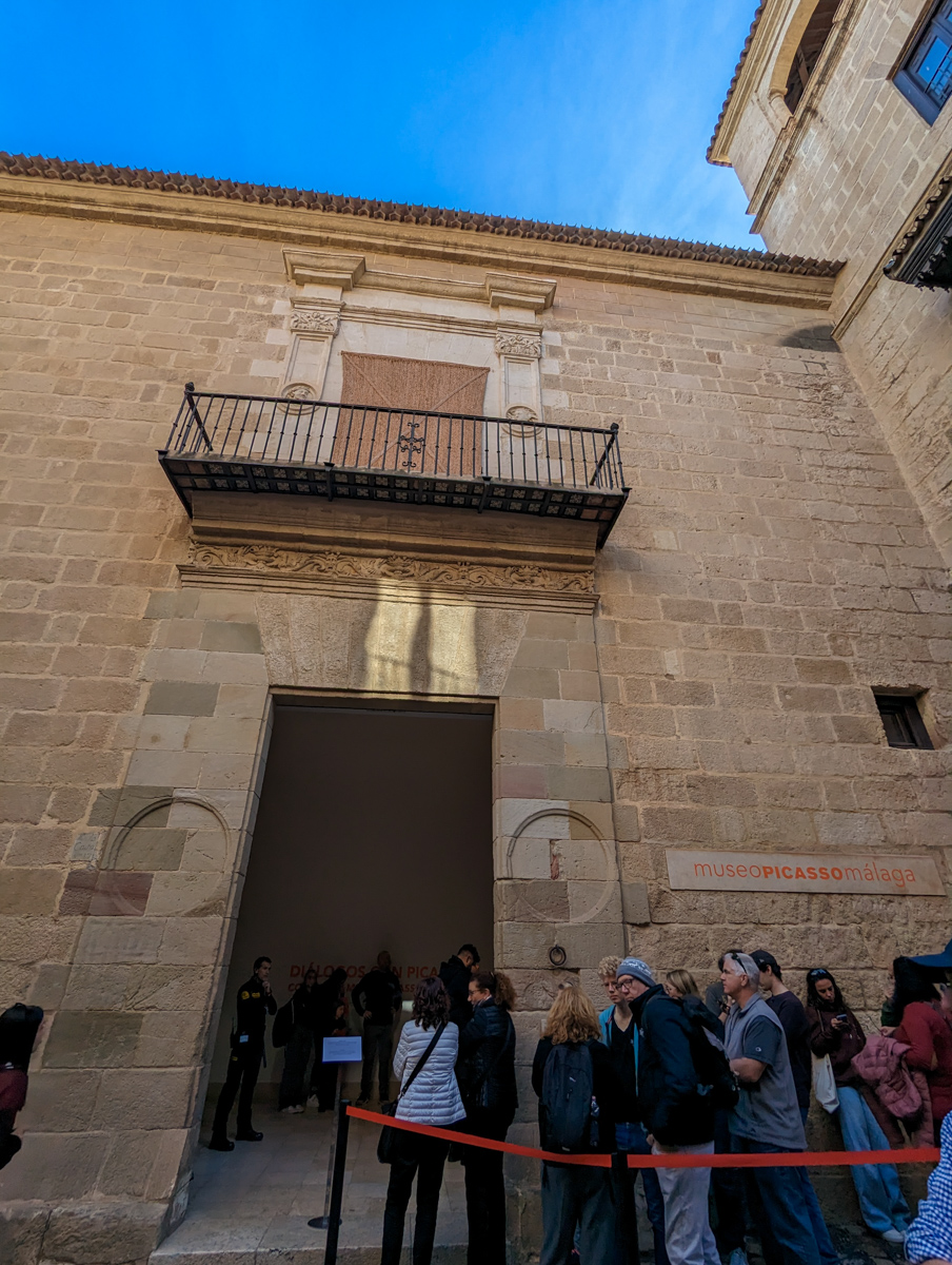 Line outside the Picasso Museum, a stone building in the heart of Malaga.