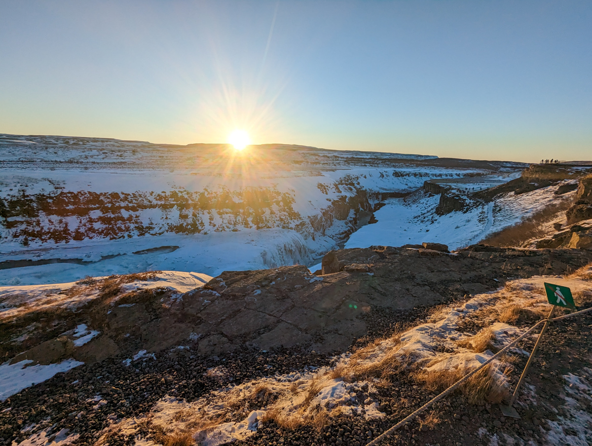 Sun over the horizon of a beautiful natural landscape at Gullfoss Falls.