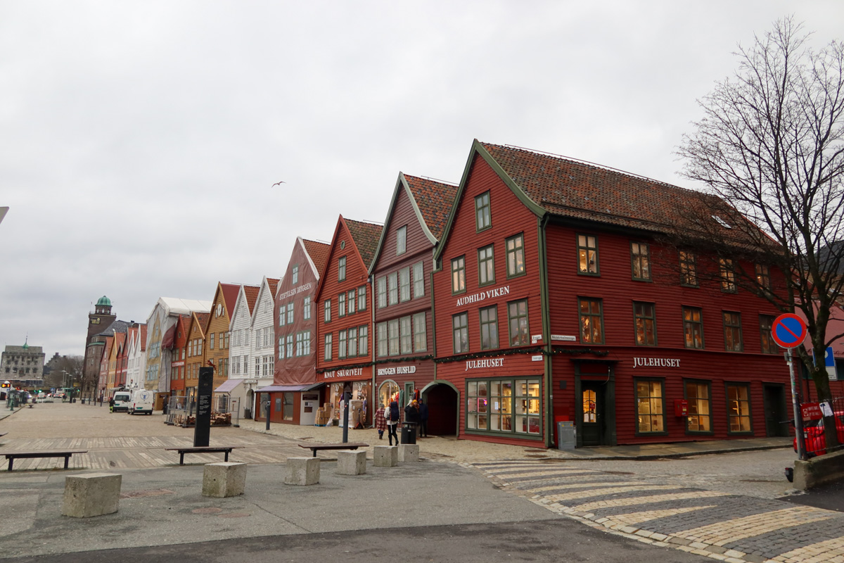 Touring around the city streets with wooden buildings and cloud over the houses.