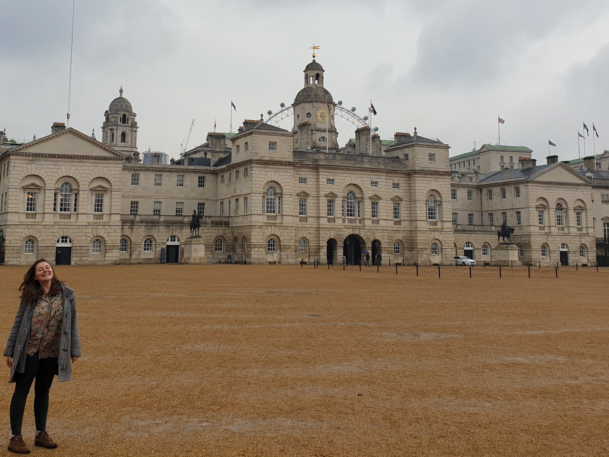 Quieter tourist attractions in London in November. Claire standing in front of part of Buckingham Palace.