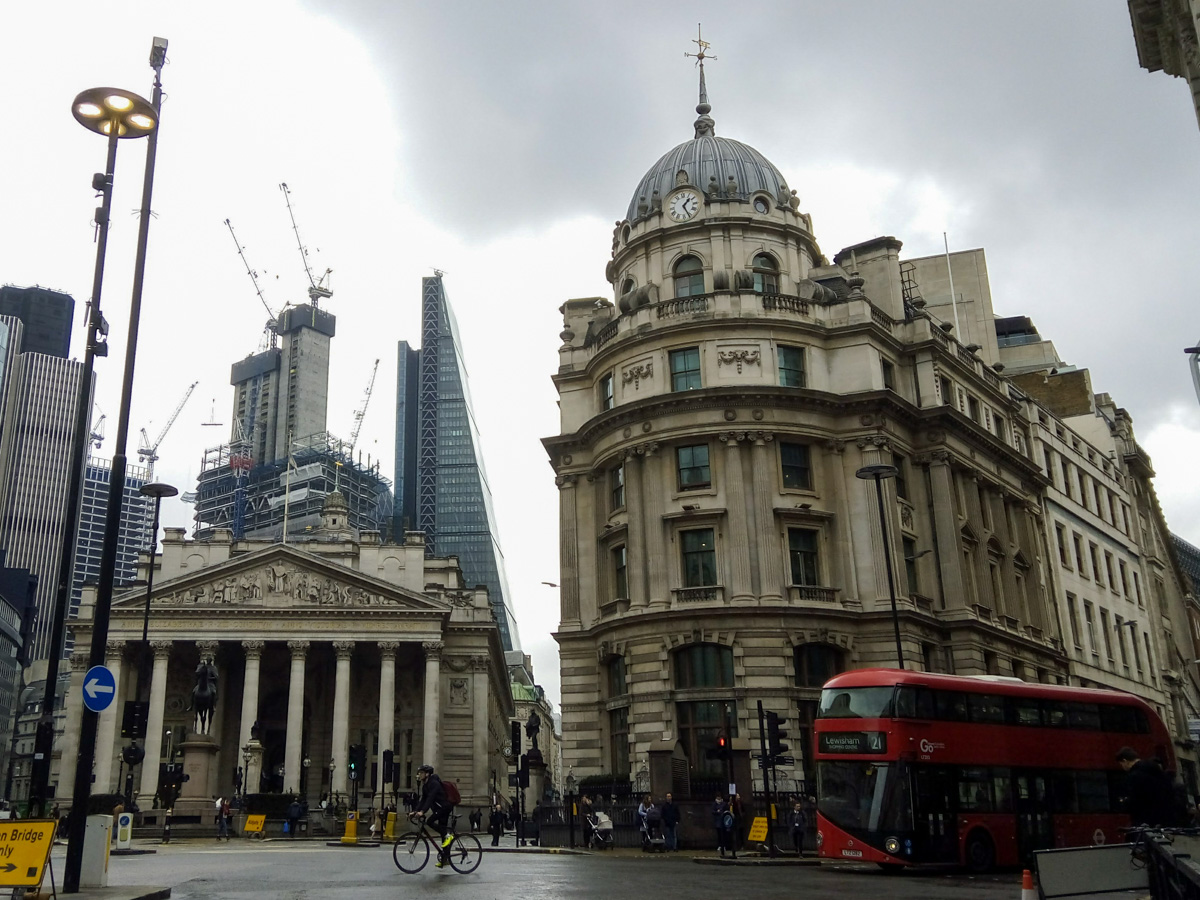 Historic buildings in London with a bus in front.
