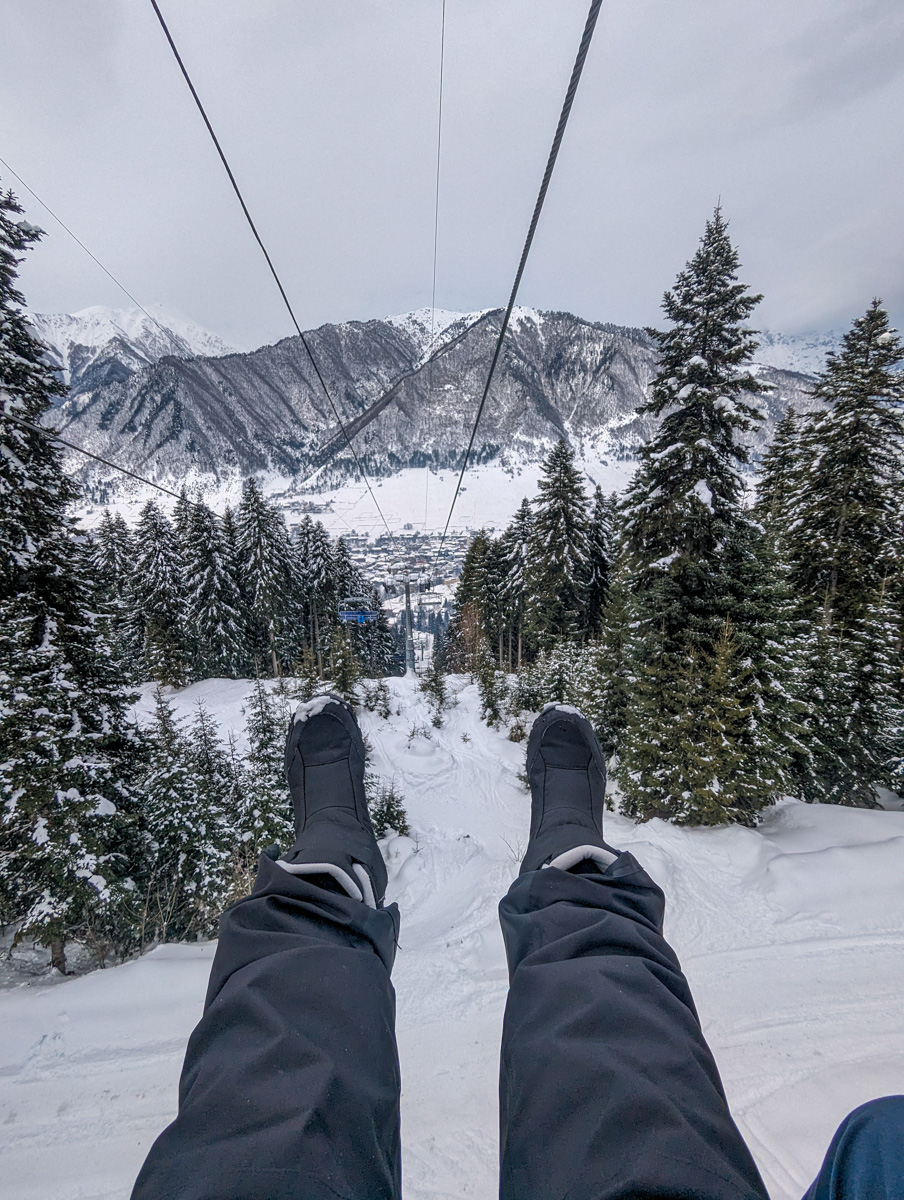 Point-of-view shot from a ski lift with skier