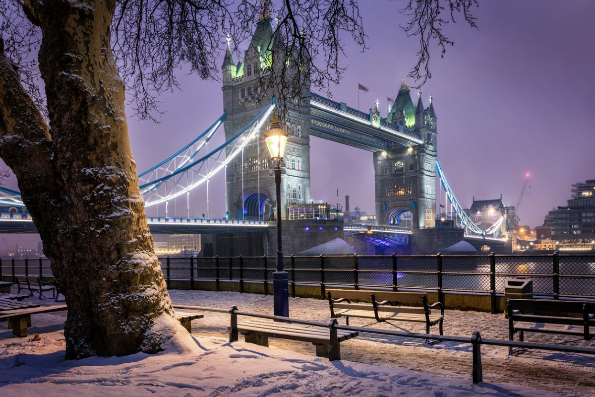 View to the Tower Bridge of London on a cold winter evening with snow