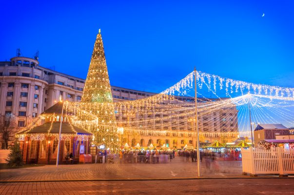 Decorated Christmas tree and lights around the market in Revolution Square in wintertime, Bucharest city of Romania