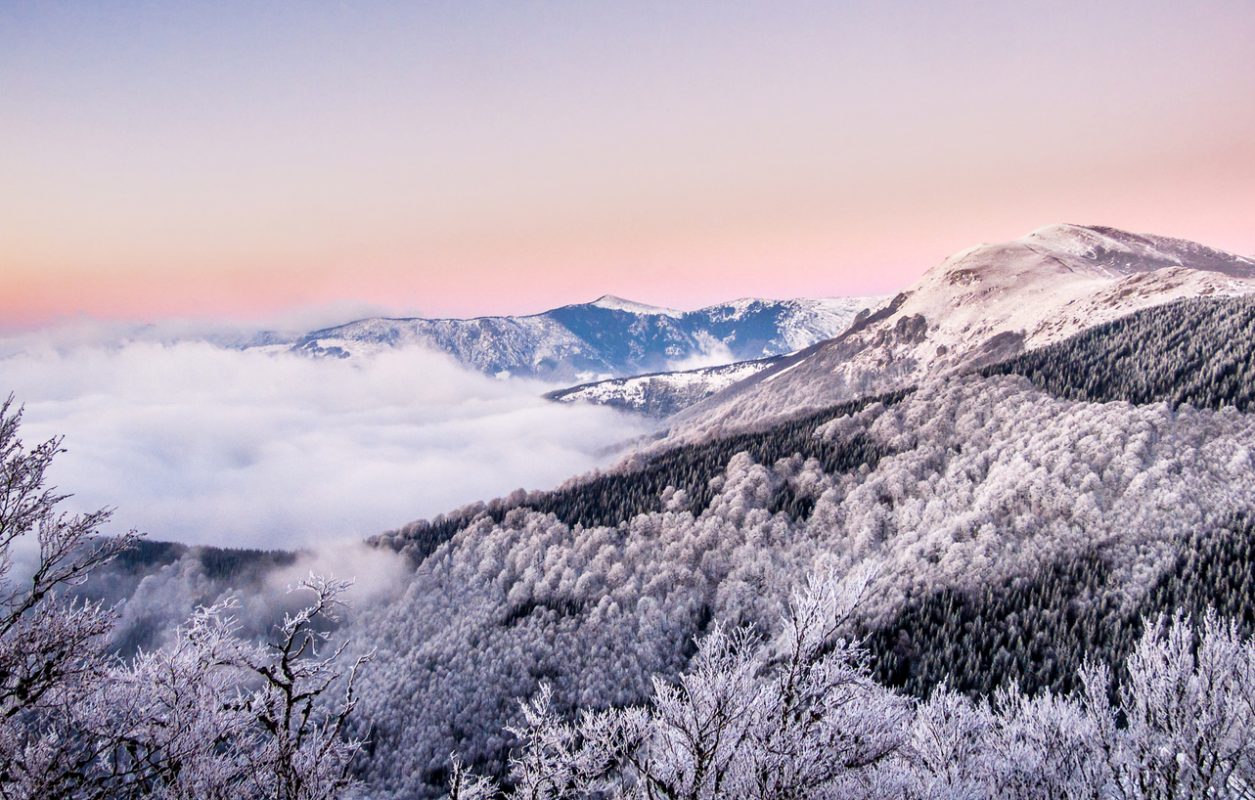 Perfect purple sunset in the white snowy mountain landscape