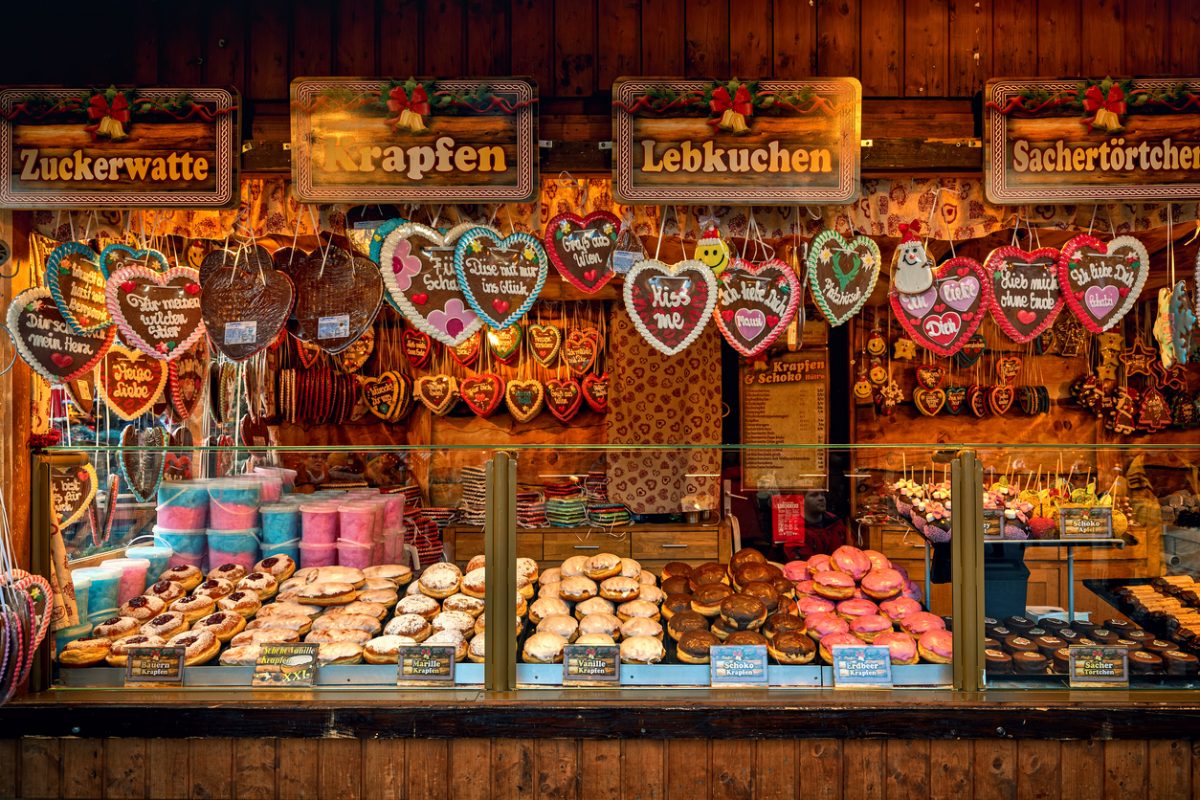 Vienna, Austria - December 03, 2019: Wooden kiosk with traditional homemade sweets and cookies on annual Christmas market held in different parts of the Vienna, Austria.