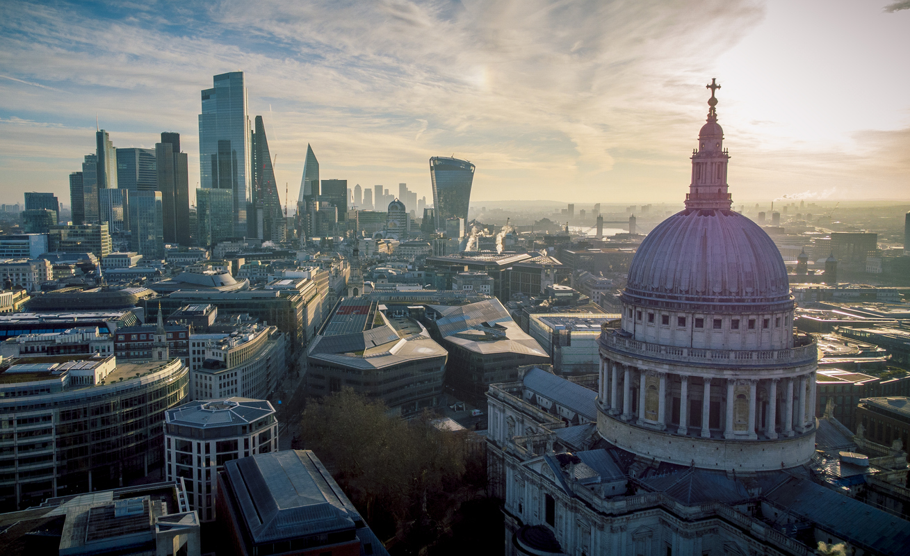 St Pauls Ancient Architecture sits proudly among the growing City behind it.