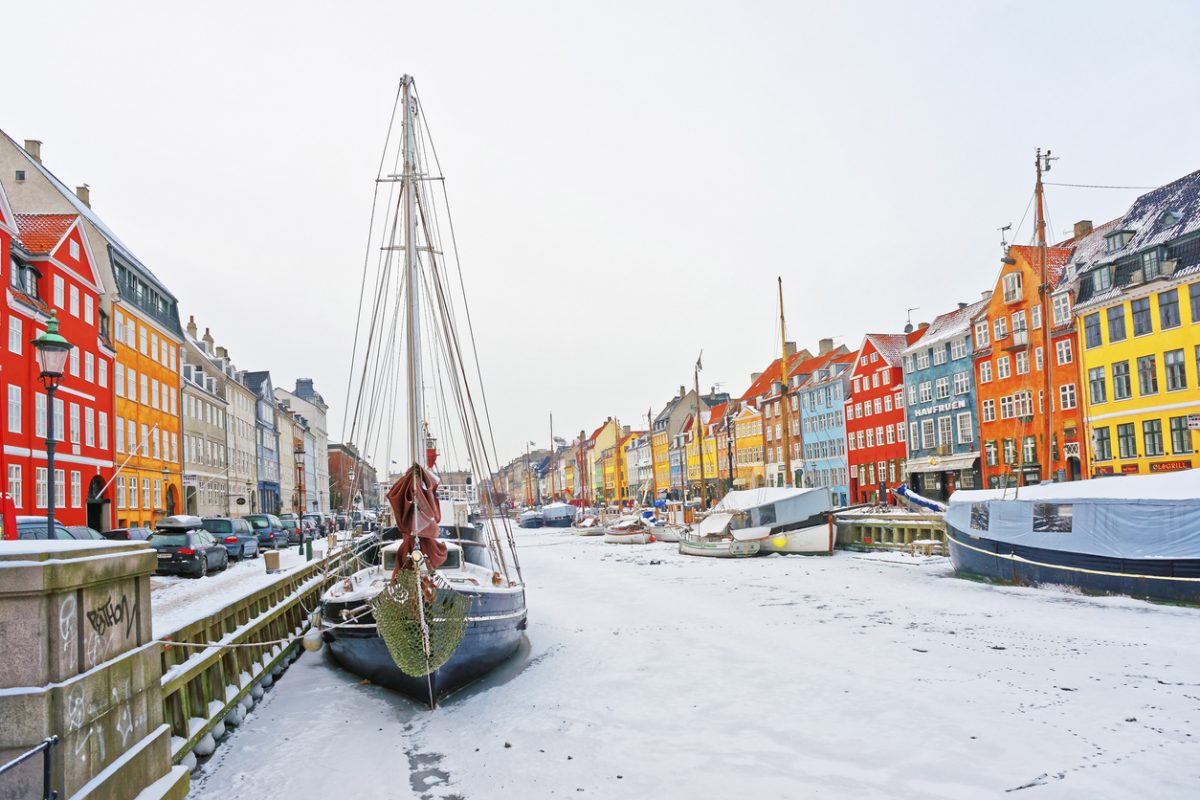 Copenhagen, Denmark - January 5, 2011: Nyhavn (New Harbor)in winter. It is waterfront, canal, entertainment district in Copenhagen in Denmark. It is lined by colorful houses, bars, cafes, wooden ships
