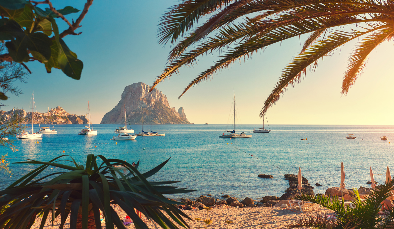 Cala d'Hort beach. Cala d'Hort in summer is extremely popular, beach have a fantastic view of the mysterious island of Es Vedra. Ibiza Island, Balearic Islands. Spain