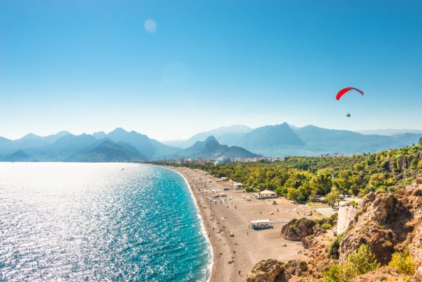 Panoramic bird view of Antalya and Mediterranean seacoast and beach with a paraglider, Antalya, Turkey, Autumn