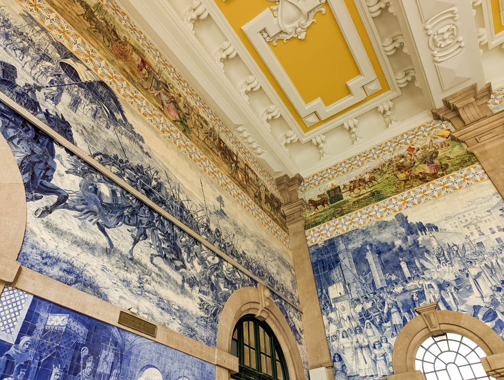 Sao Bento Train station, one of the best places to visit in Porto in winter. You can see the blue tiles, called azulejos, which depict different scenes from Portuguese history. 
