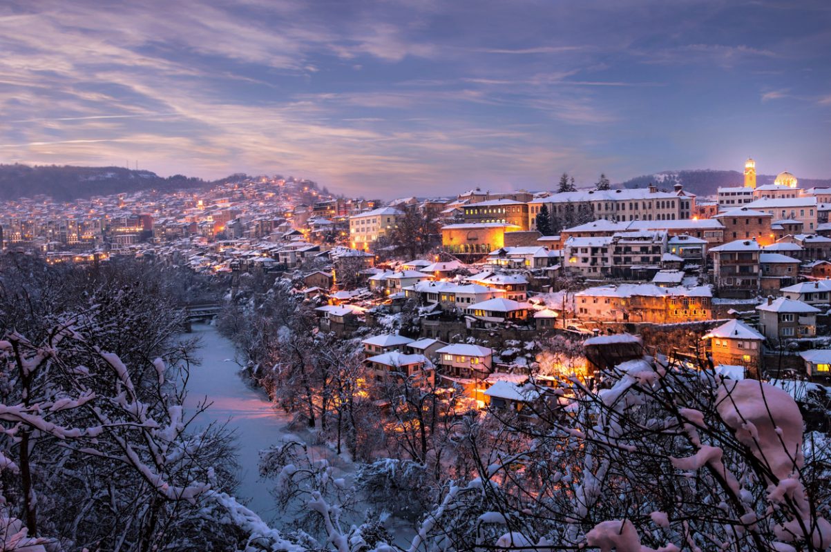Beautiful view to a small town and frozen river after sunset, Winter city Veliko Tarnovo, Bulgaria, city lights