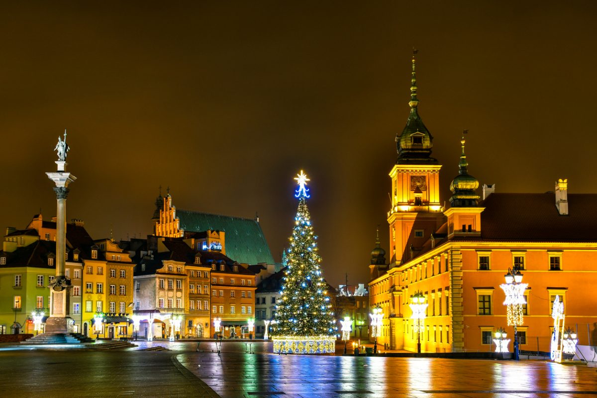 Warsaw, Poland - December 25, 2019: Panorama of Castle Square with Christmas tree, Sigismund's Column and The Royal Castle by night.