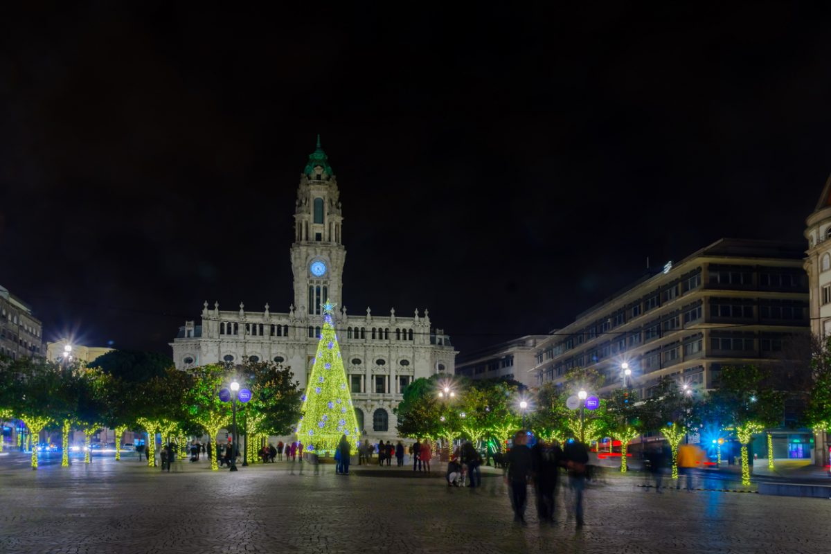 PORTO, PORTUGAL - DECEMBER 24, 2017: Night scene of the Avenida dos Aliados, and the city hall, with a Christmas tree, locals and visitors, in Porto, Portugal